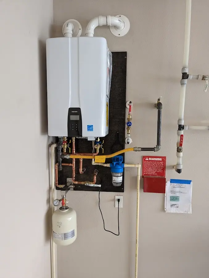 Professional plumber installing copper piping in a Springdale home